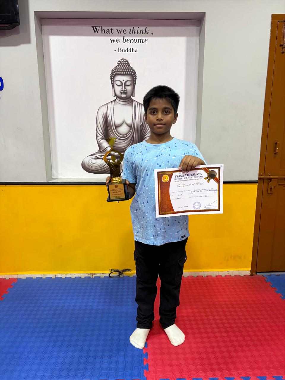 Student with trophy at the Hustle Karate dojo